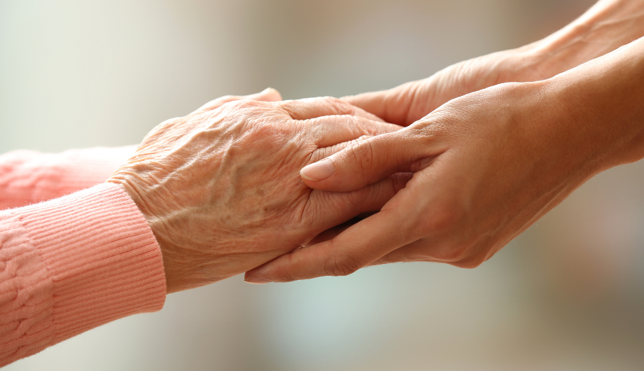 Old woman set of hands, and a young persons hand
