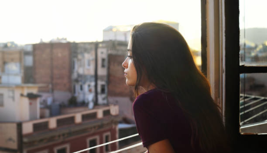 Woman looking out over balcony