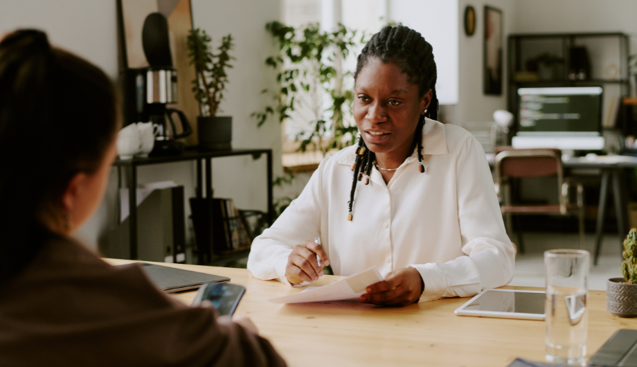 Two women talking and working together.