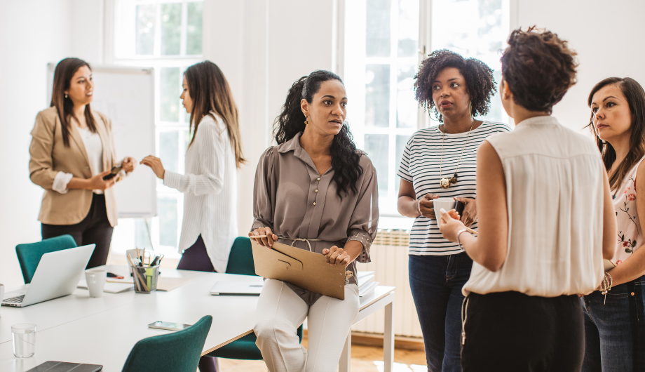 A diverse group of women talking.