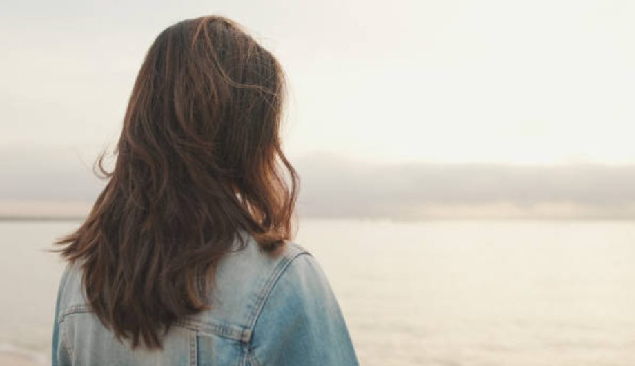 Back of woman's head looking into landscape