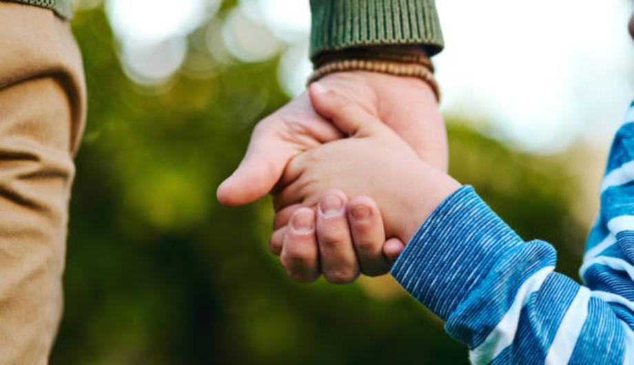 Father and Son holding hands, zoomed in image