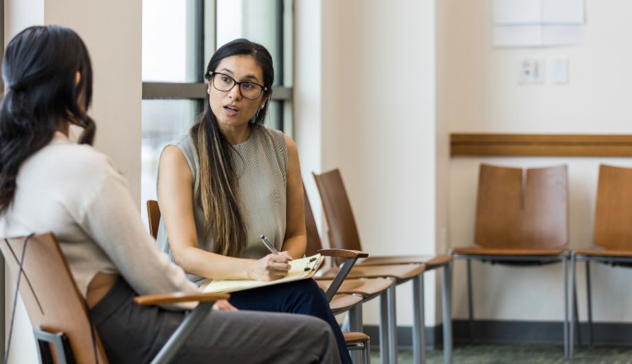 Woman talking while another woman takes notes