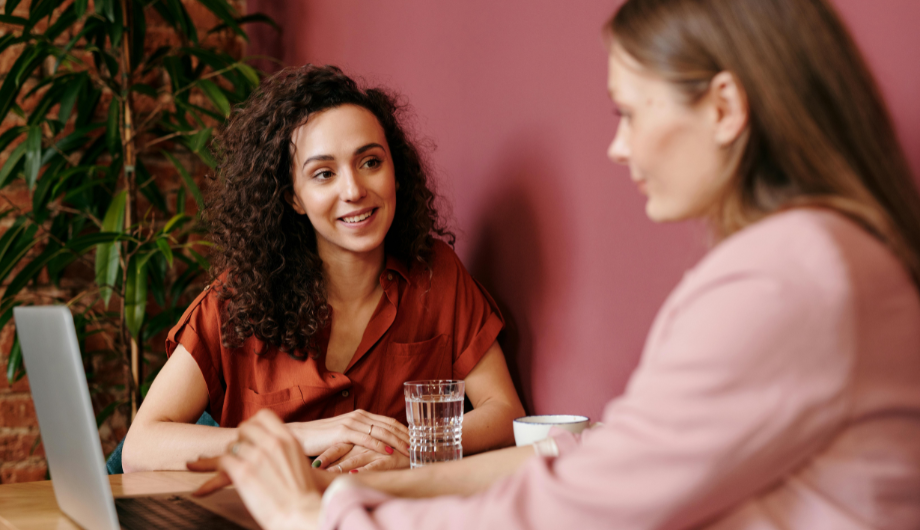 Two women talking and working together.