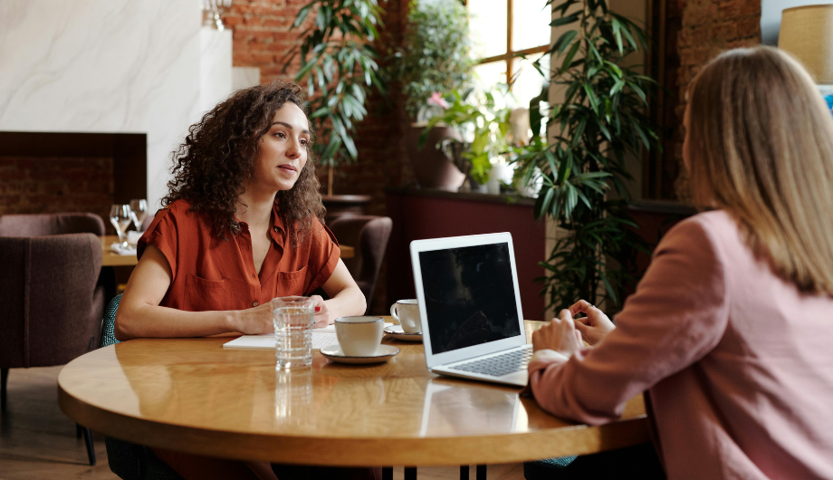 Two women talking and working together.