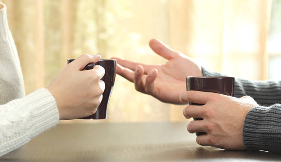 Zoomed in image of hands in an expressive way, with coffee mugs