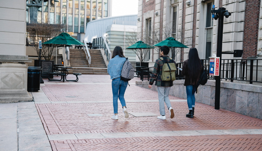 Three young people walking along a path