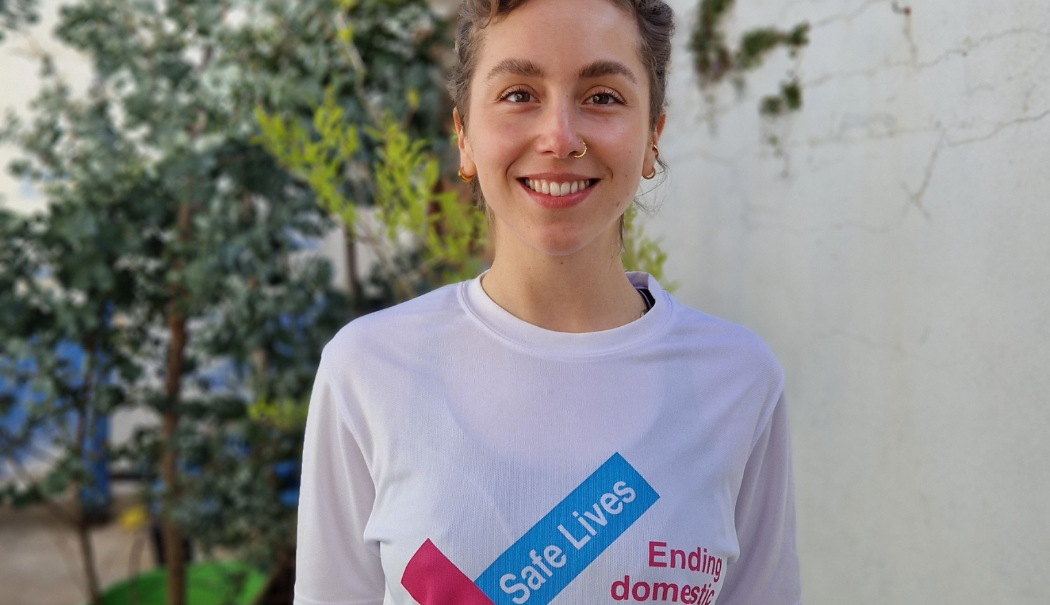 A woman wearing a SafeLives fundraising T-shirt.