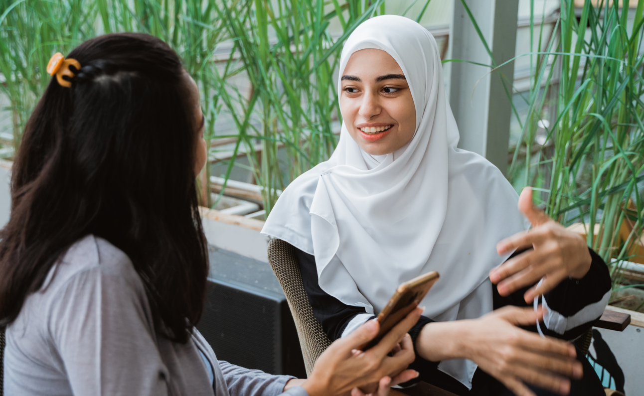 woman wearing hijab, having a conversation